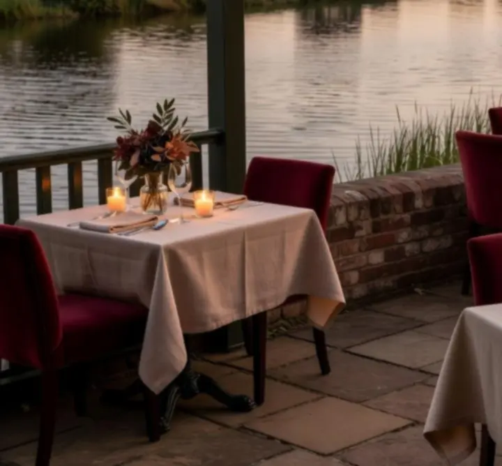 Candlelit riverside dining table overlooking the Norfolk Broads